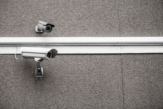 Two surveillance cameras on a building wall