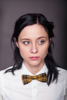Girl brunette office worker with bow tie