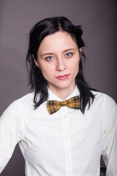 Girl brunette office worker with bow tie