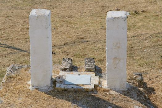 old well in the countryside with two white columns