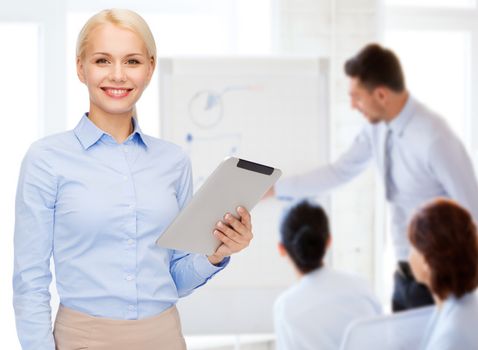 business, internet and technology concept - smiling woman looking at tablet pc computer