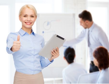 business, internet and technology concept - smiling woman looking at tablet pc computer showing thumbs up