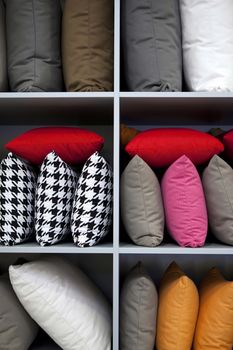 Decorating with colorful cushions on wooden shelves
