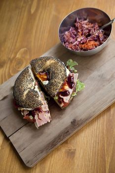 Gastronomic bagel on a wooden board