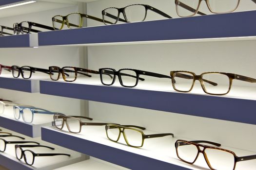 Glasses on shelves in a optician shop