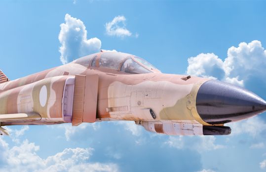 Fighter aircraft nose and cabin detail with blue sky background