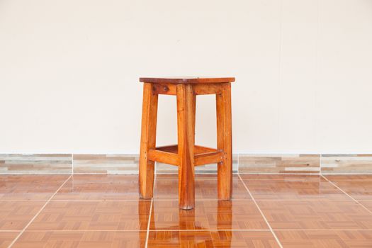wooden Chair. The square is located at home. Behind the white wall