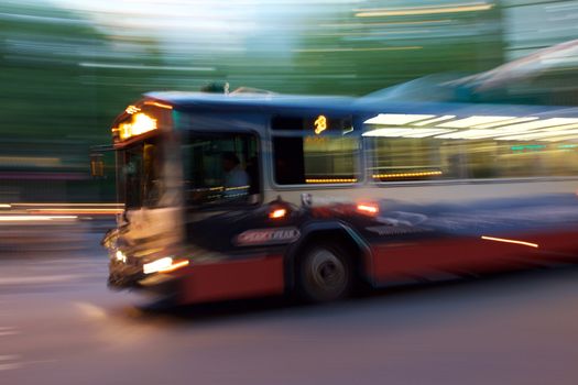 Intentional blur of a city bus in the evening