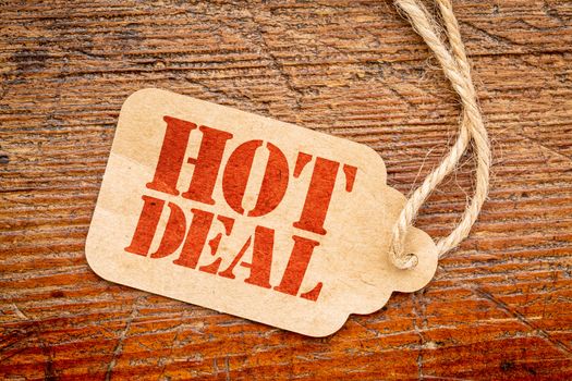 hot deal sign a paper price tag against rustic red painted barn wood