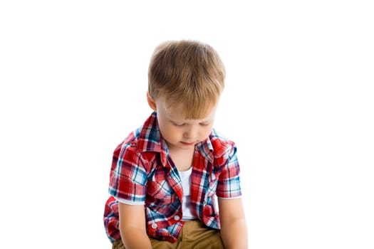 little boy in a plaid shirt over a white background.