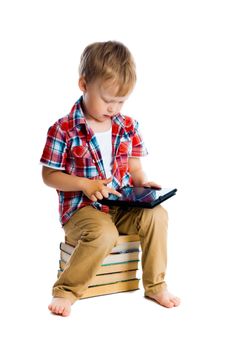 little boy in a plaid shirt with a tablet computer against a white background.