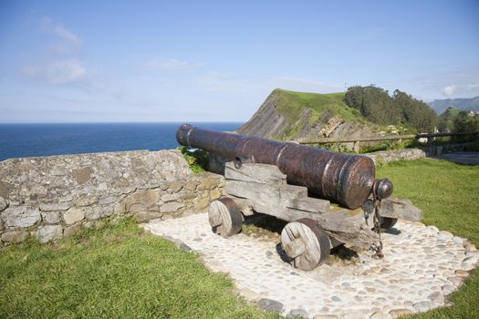 ancient bronze cannon waterfront in Ribadesella city Asturias Spain Europe
