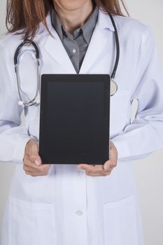 woman doctor hands with white gown and stethoscope showing black blank screen mobile tablet over white background