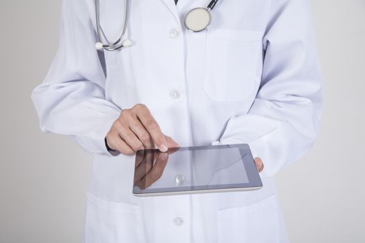 woman doctor hands with white gown and stethoscope using black blank screen mobile tablet over white background