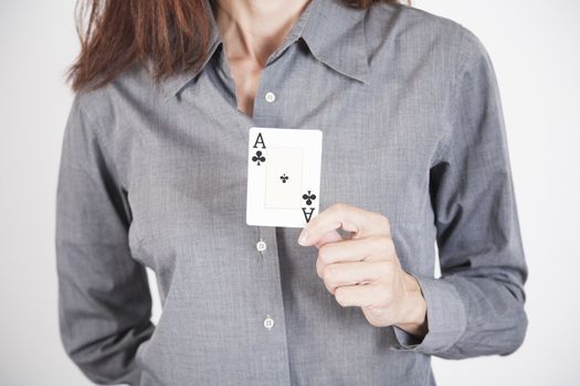 woman with grey shirt showing black clover ace card in her hands isolated over white background