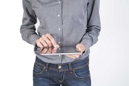 woman blue jeans trousers and grey shirt with digital tablet blank screen in her hand isolated over white background