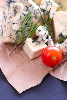 Roquefort cheese composition on dark background