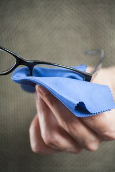 woman hands cleaning glasses with blue cloth