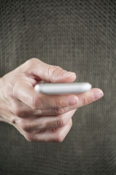 blank screen smartphone in woman hand with green jersey