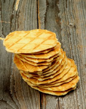 Stack of Crunchy Thin Waffles isolated on Rustic Wooden background
