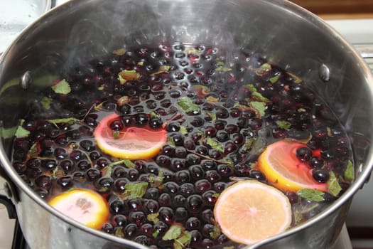 chernoplodki compote with lemon and mint in cooking