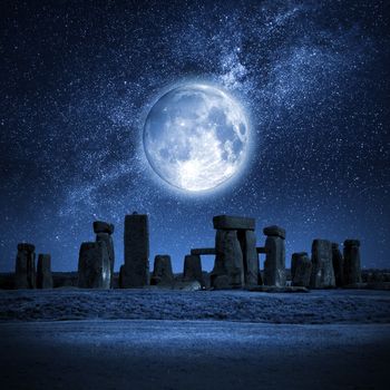 An image of Stonehenge with a full moon