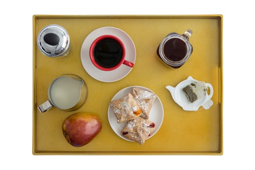 High Angle View of Breakfast Tray for Two with Tea, Coffee, Pastries and an Apple Spread Out for Enjoyment