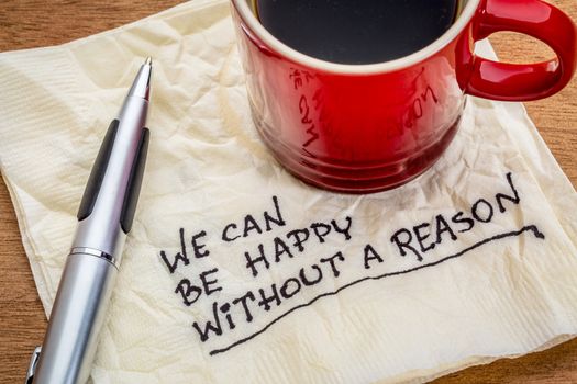 We can be happy without reason - inspirational words - handwriting on a napkin with cup of coffee