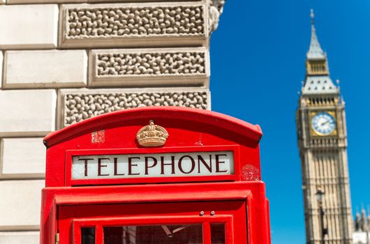 Red Telephone Booth and Big Ben in London street.
