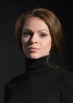 Portrait of young beautiful woman close up on dark background