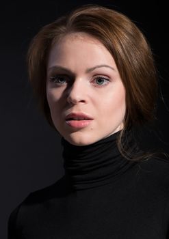 Portrait of young beautiful woman close up on dark background