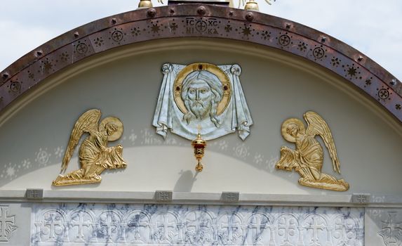 Lunette on Orthodox church with face of Jesus and two angels 