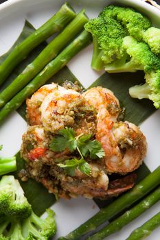 Shrimp scampi seafood dish with broccoli and asparagus.