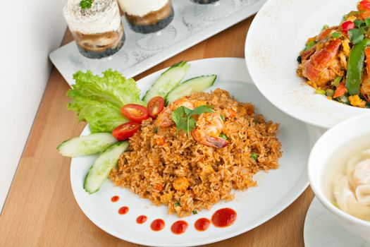 Sriracha shrimp fried rice dish with garnish dots of siracha sauce.