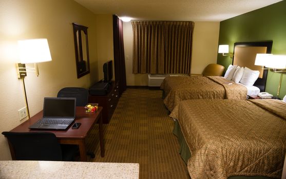 An upscale hotel room with kitchen and desk