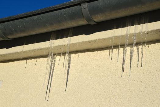 Photo of icicles on a water pipe. Winter photography.