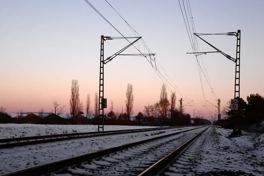 Photo of a railway station platform with electricity transmission system. Taken in Germany.