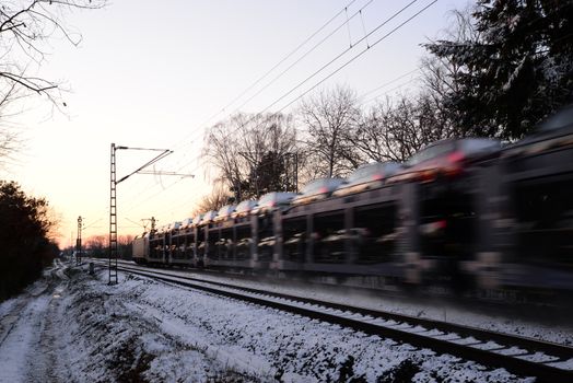 Photo of a fast moving train with cars. Business theme. Taken in Germany.