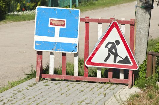 city street road repair signs on pavement