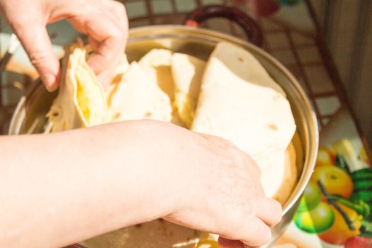 The hostess cooks kastyby with mashed potatoes on the kitchen table  