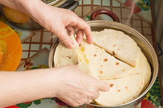 The hostess cooks kastyby with mashed potatoes on the kitchen table  