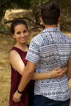 Girlfriend looking forward while hugging boyfriend