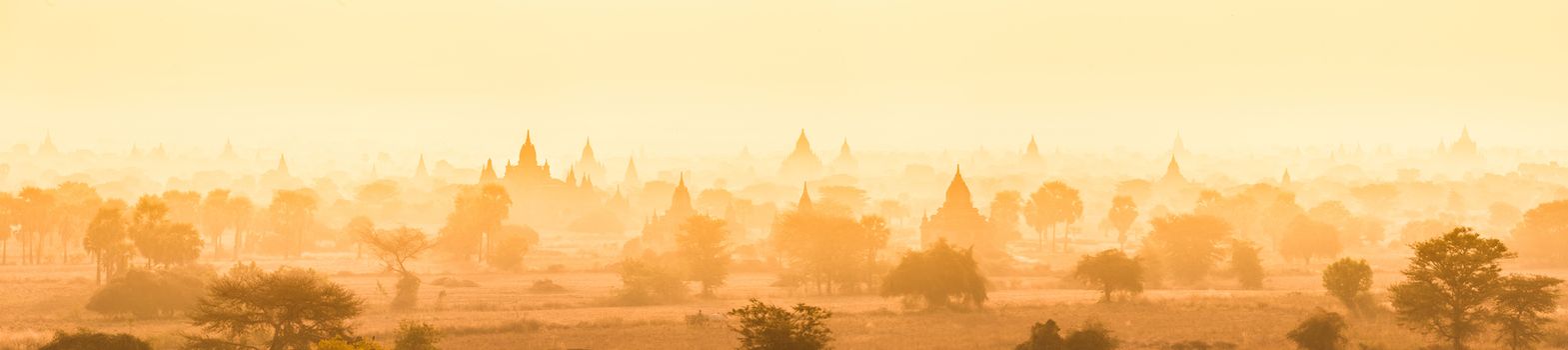 Temples of Bagan an ancient city located in the Mandalay Region of Burma, Myanmar, Asia. yellow toned. Thumbnail format. Vertical panoramic composition.