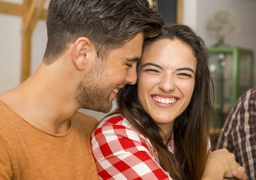 Happy couple at the restaurant talking and smiling