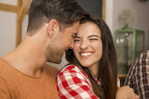 Happy couple at the restaurant talking and smiling