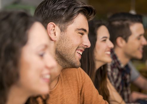 Multi-Ethnic Group of happy friends having fun at the restaurant