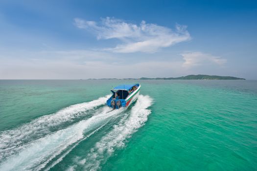 Speed boat to island in the sea two colors