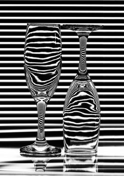 Two empty glasses with bands of reflection blinds