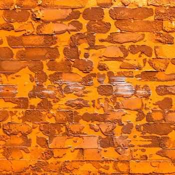 pattern orange color of modern style design decorative uneven cracked real cement wall .