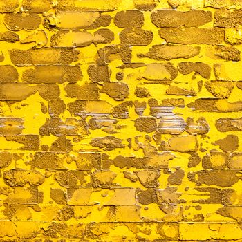 pattern yellow color of modern style design decorative uneven cracked real cement wall .